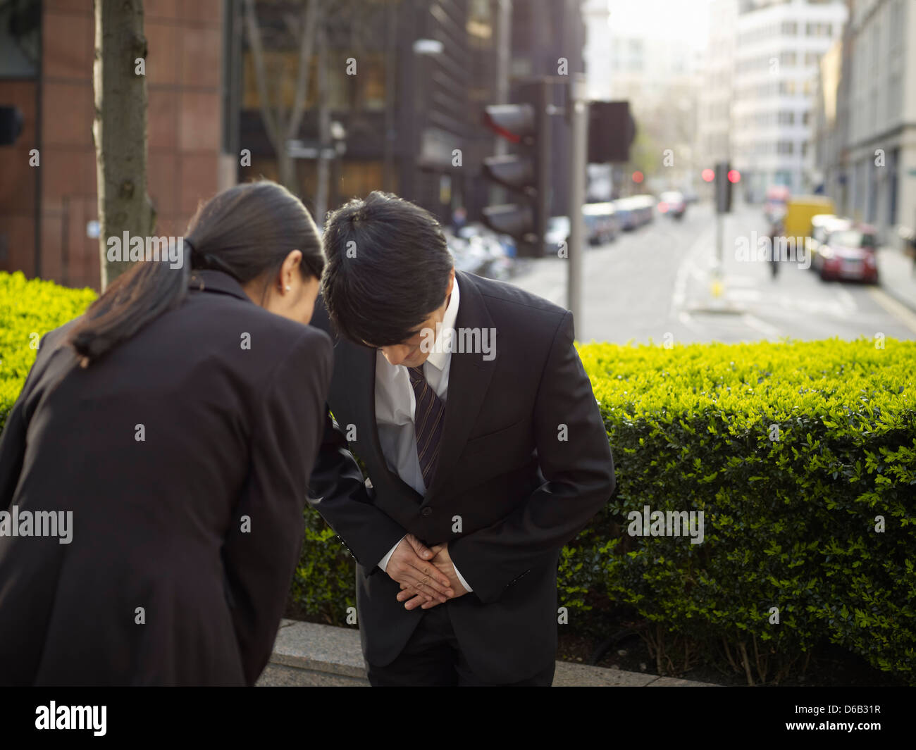 business-people-bowing-to-each-other-D6B31R.jpg